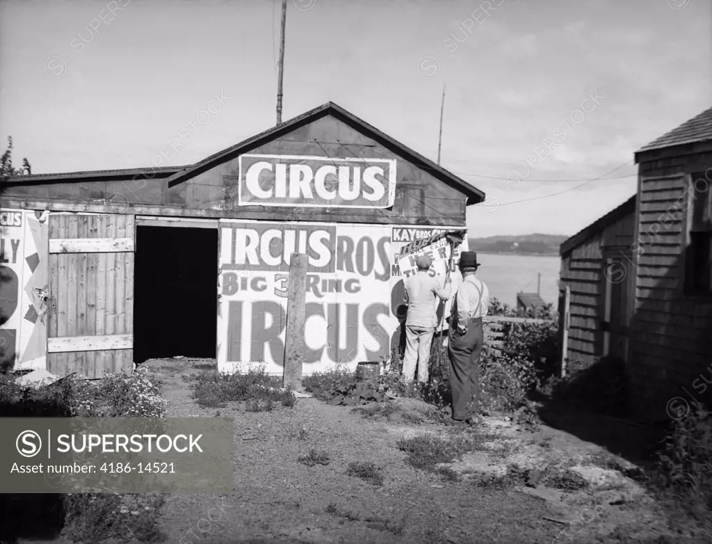 1920S Bill Posters Sticking Signs On The Side Of A Barn Advertising A Traveling Circus