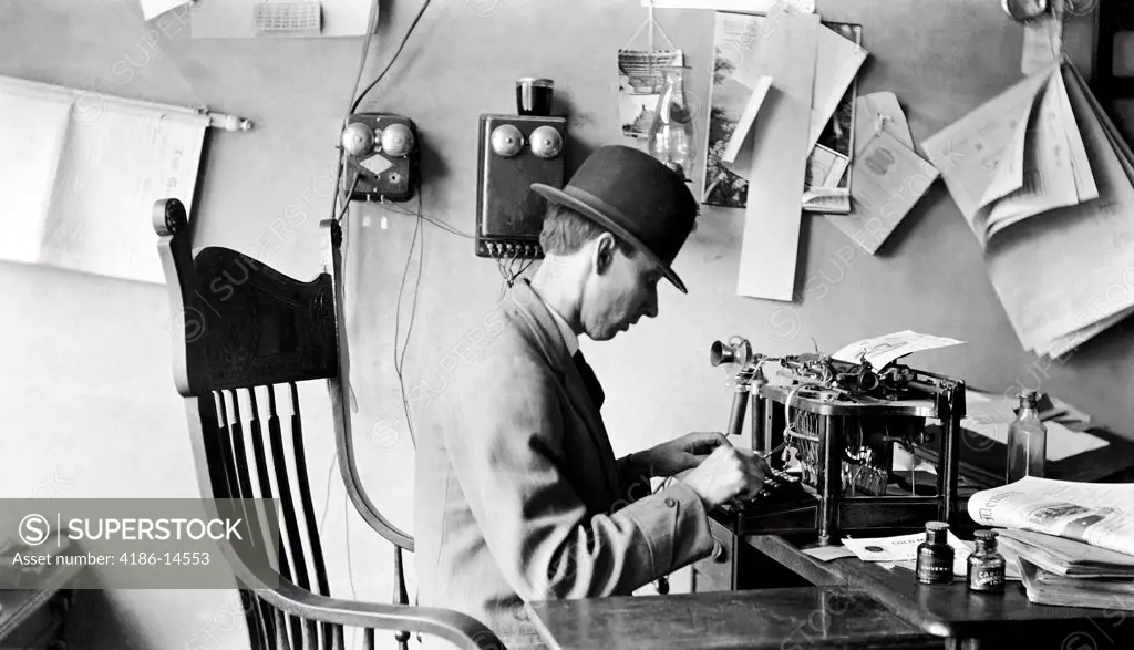 1900S Man Wearing Bowler Hat Typing In Office