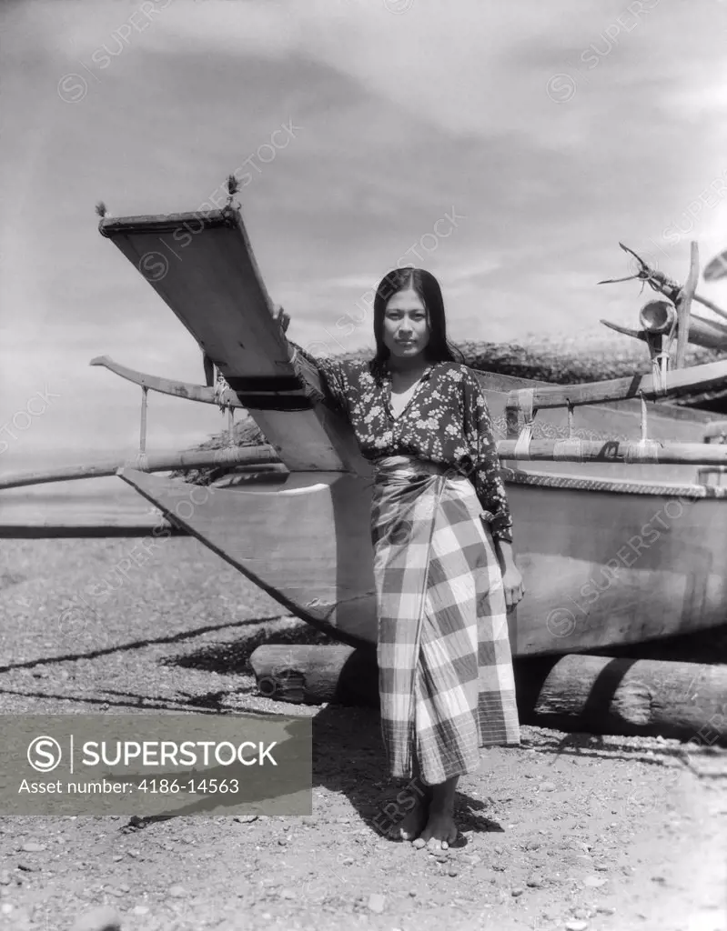 1930S 1940S A Moro Girl Native Costume Standing By Catamaran On Beach In Zamboanga