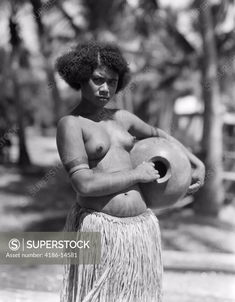 1920S 1930S Serious Unsmiling Portrait Topless Papuan Girl Native In Grass Skirt New Guinea
