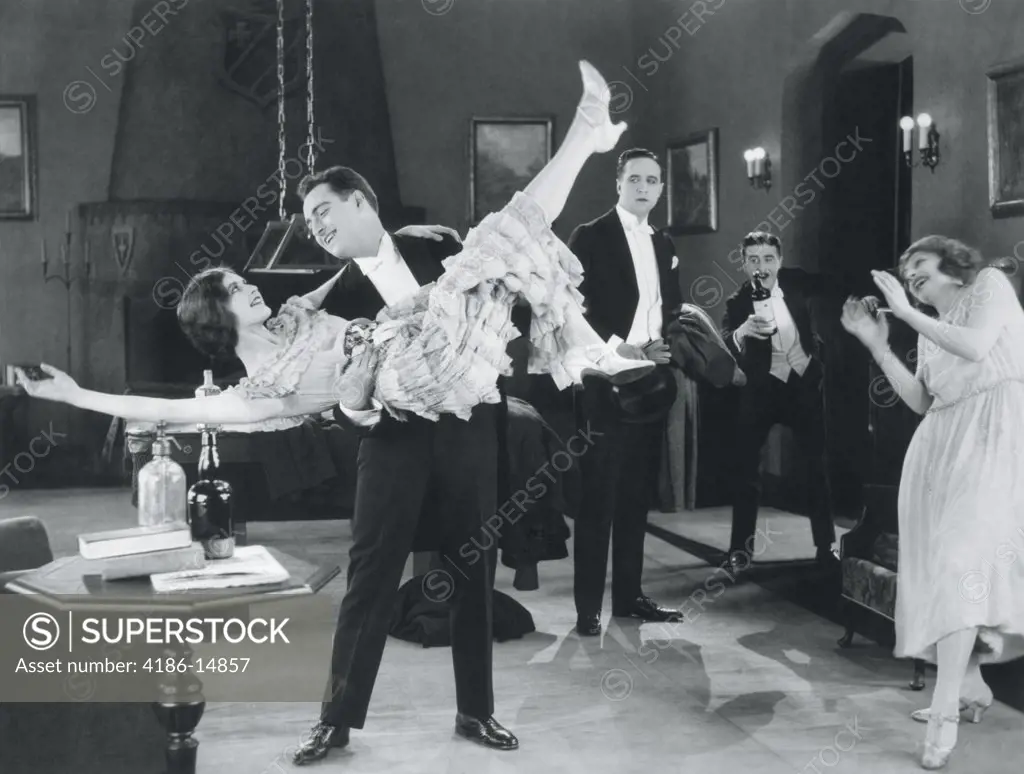 1920S Movie Still Of Wild Party With Woman Flapper Turned Upside-Down In Arms Of Man Dancing