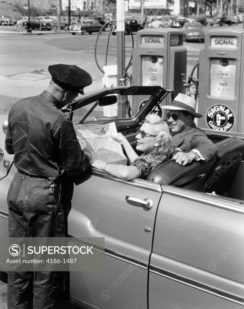 1950S Couple With Map In Car Convertible Asking Directions From Gas Station Attendant