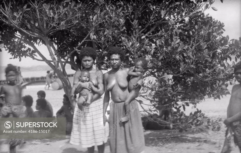1920S 1930S Two Native Women Mothers Topless Wearing Skirts Holding Infant Baby Children New Guinea