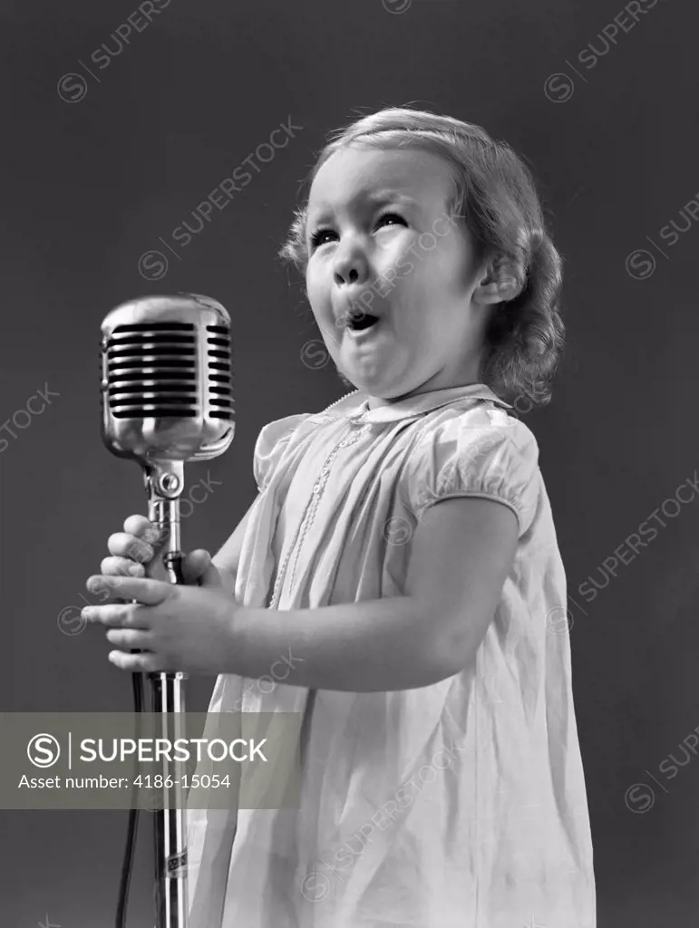 1940S Little Girl Making Face Singing Into Microphone