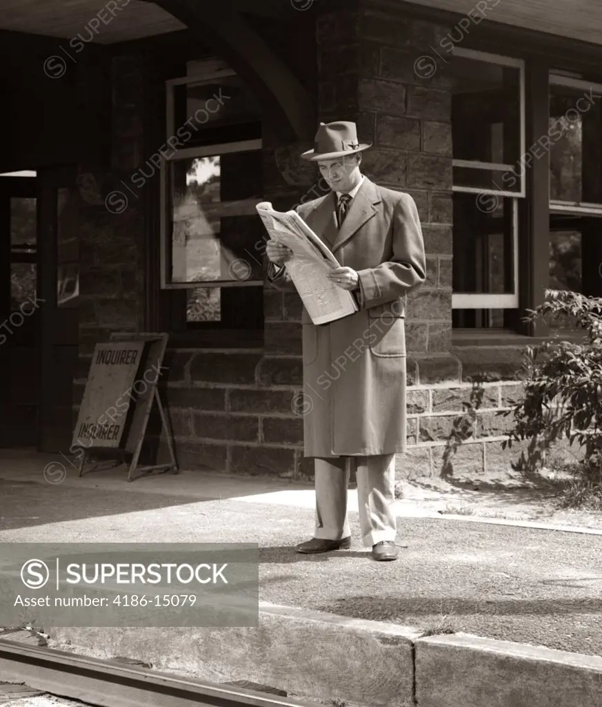 1950S Man Businessman Commuter On Railroad Station Platform Reading Newspaper Waiting For Train