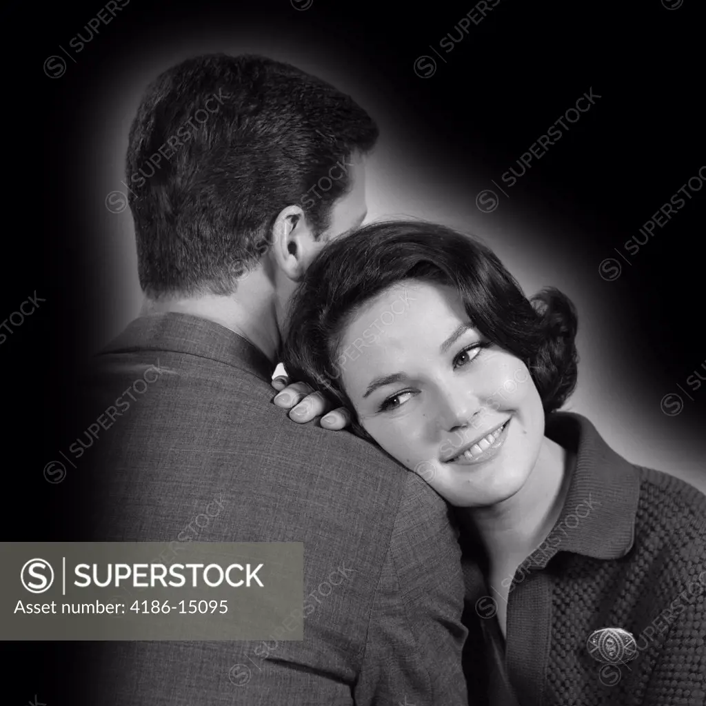 1960S Couple Man With Back To Camera & Smiling Woman Facing Camera With Head On His Shoulder