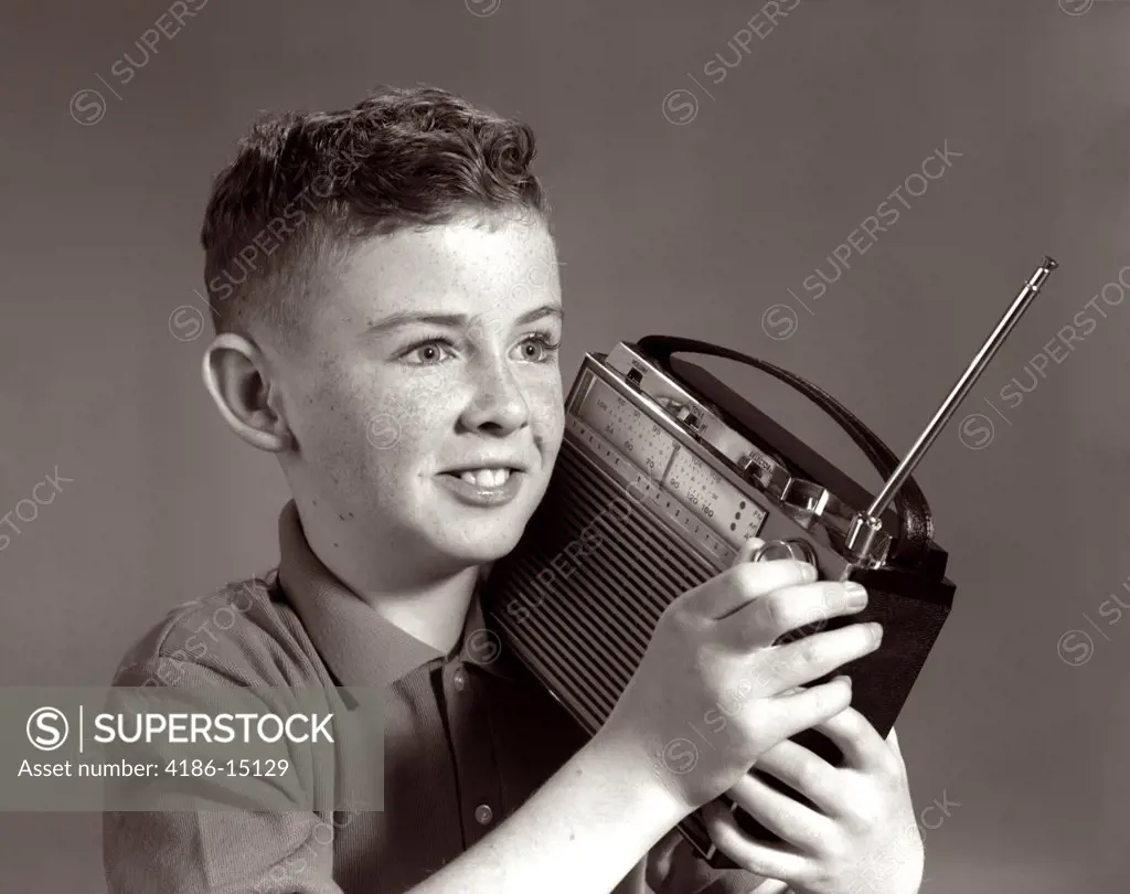 1960S Boy Listening To Portable Radio Indoor