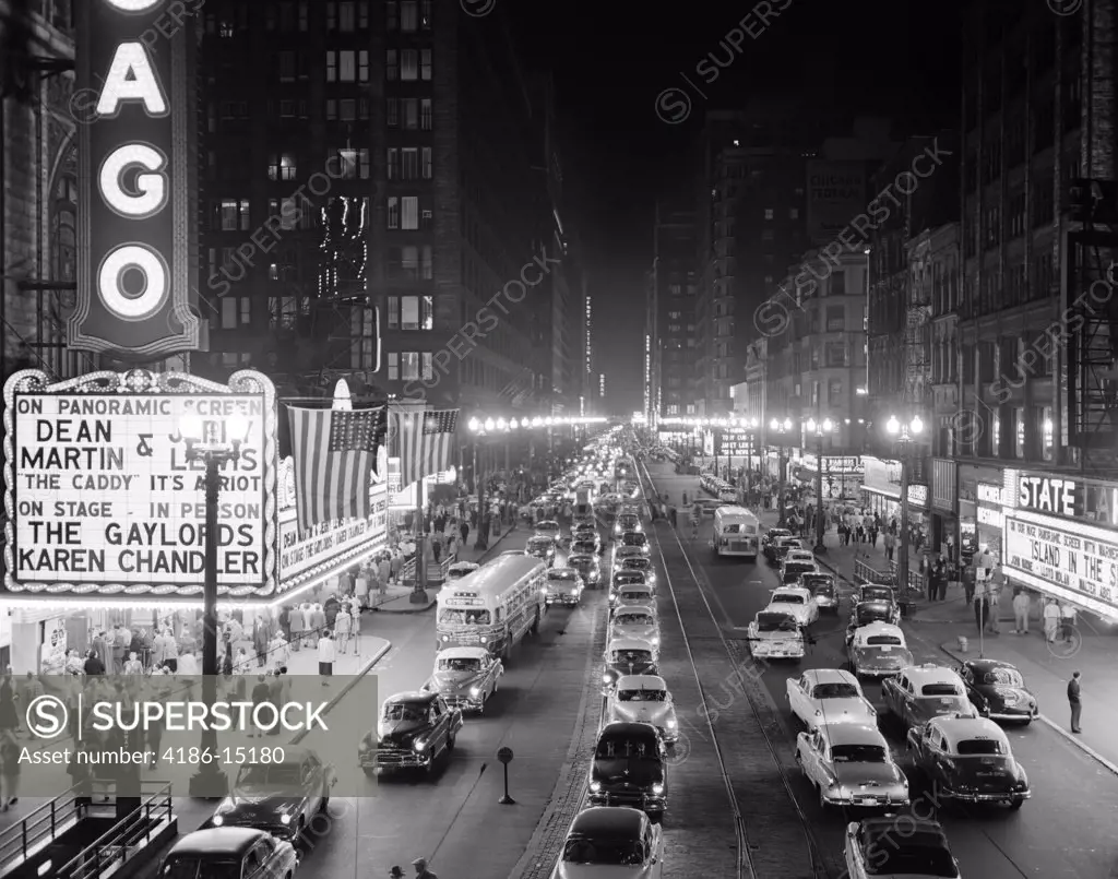 1950S 1953 Night Scene Of Chicago State Street With Traffic And Movie Marquee With Pedestrians On The Sidewalks
