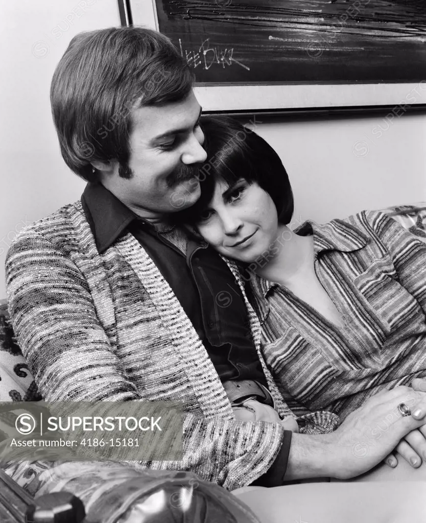 1970S Romantic Couple Man Woman Hugging Sitting On Sofa