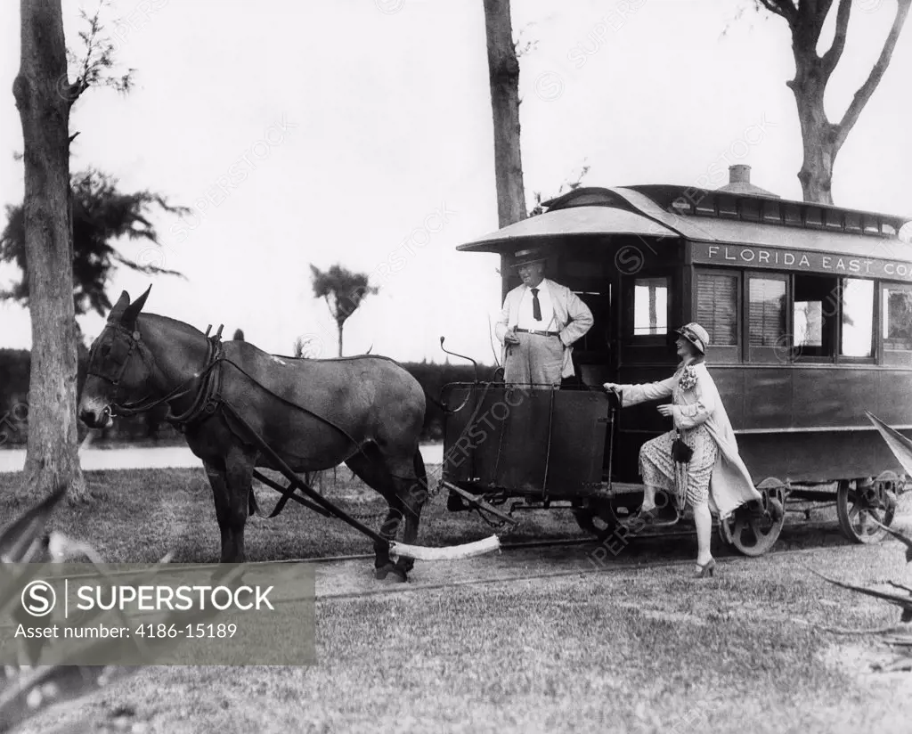 1920S Woman Stepping Up Onto Mule-Drawn Train Car With Conductor Driver Standing At Front