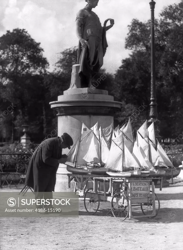 1930S Paris France Tuileries Gardens Man With Cart Of Miniature Toy Sailboats For Rent