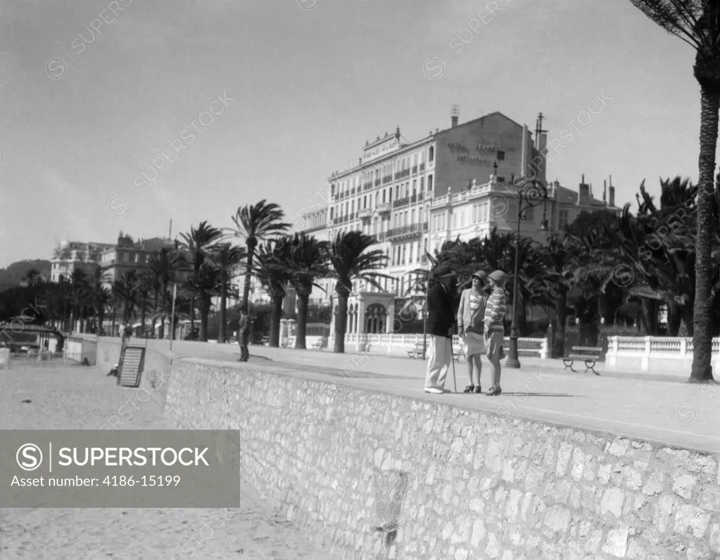 1920S 2 Women 1 Man Stand Talking On Promenade Cannes French Riviera Fashion Mediterranean Retro Vintage