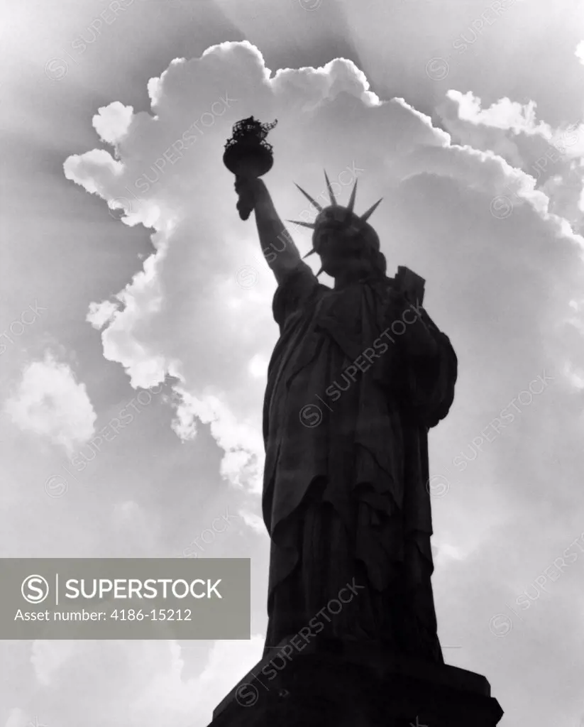 Silhouette Of Statue Of Liberty With Clouds Behind Her