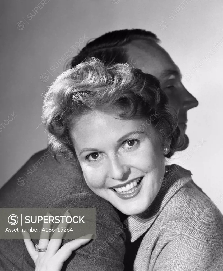 1950S Smiling Woman Hugging Man Head On His Shoulder