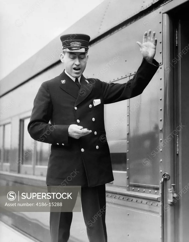 1930S Conductor Making Final Boarding Call Outside Train