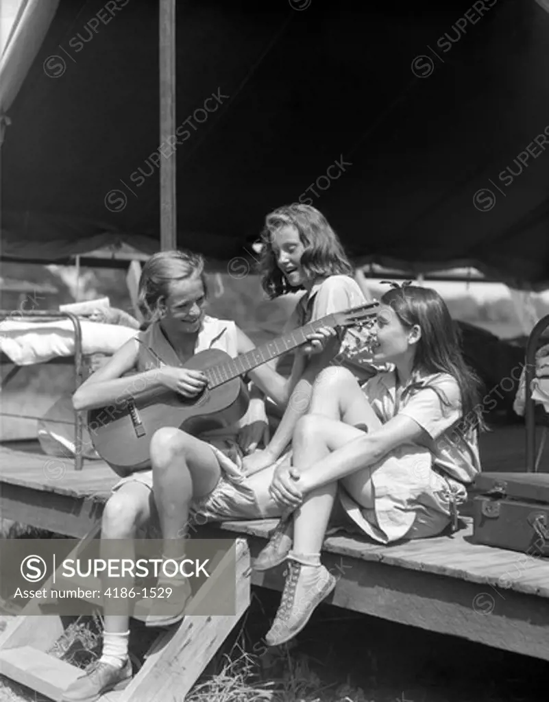 1930S Three Girls At Summer Camp Having Sing-Along One Playing Guitar