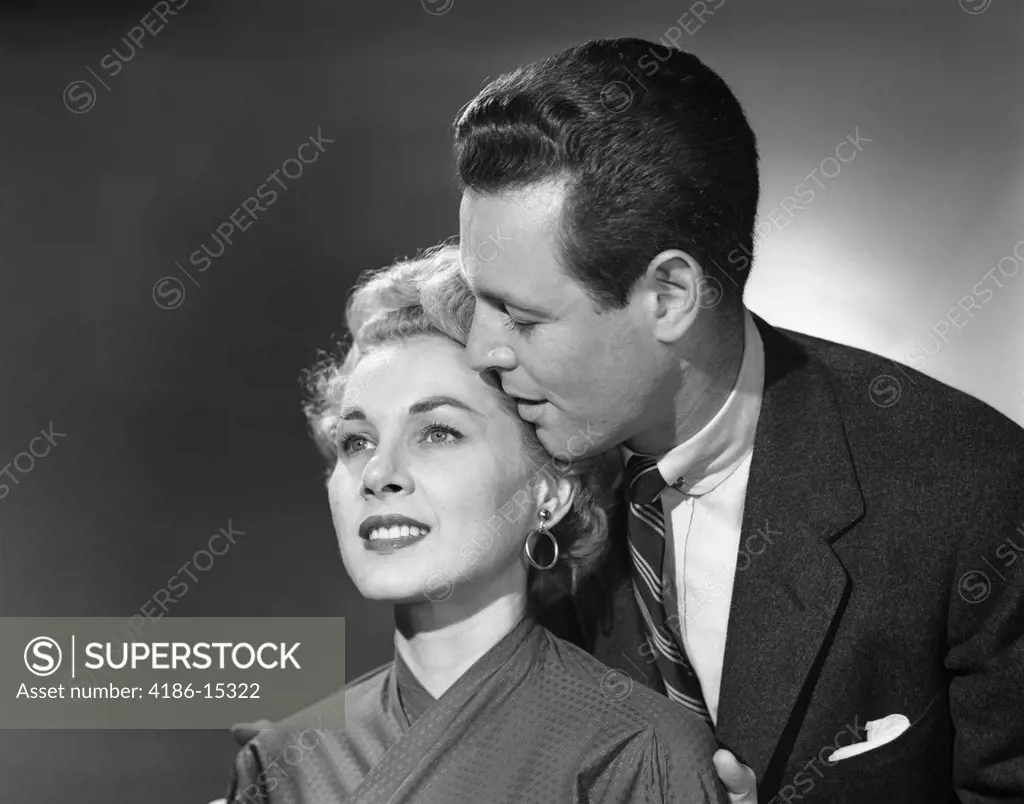 1950S Portrait Of Romantic Couple Man Whispering In Woman'S Ear