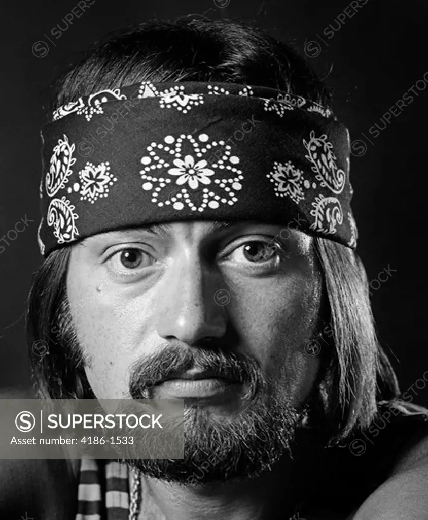 1970S Portrait Male With Long Dark Hair & Beard & Mustache Wearing Gold Chain Striped Tank Top & Bandana Around Head