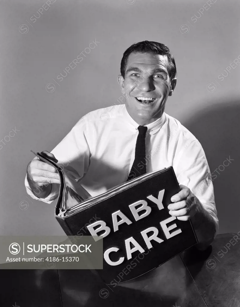 1960S Smiling Man Father Holding Baby Care Book