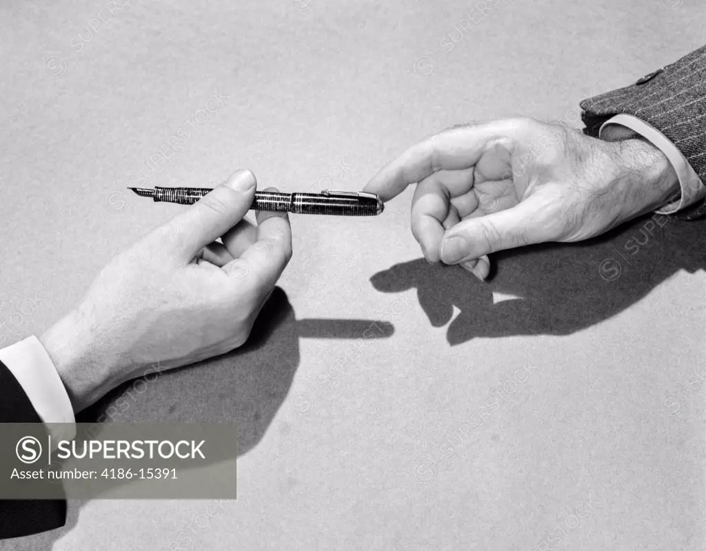 1940S Fountain Pen Being Passed From One Businessman'S Hand To Another'S