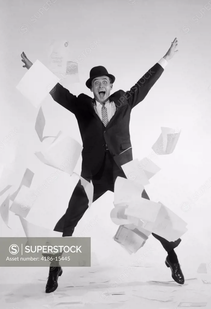 1950S Man In Business Suit And Hat Jumping Papers Flying Exaggerated Expression