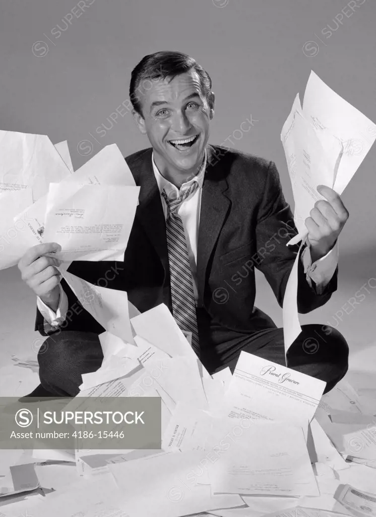 Happy Businessman Sitting In A Pile Of Paper Holding Handfuls Of Letters Studio Symbolic 1960S