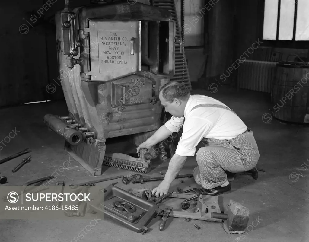 1930S Man Plumber Converting Coal Burning Furnace To Gas Fired Heating Boiler
