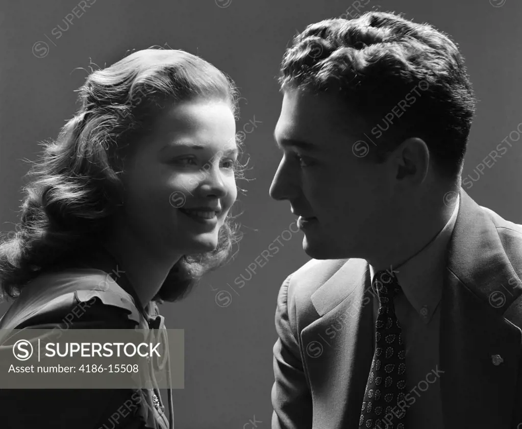 1940S Smiling Couple With The Key Light On The Woman'S Face & The Man In Shadow Dramatic Romantic