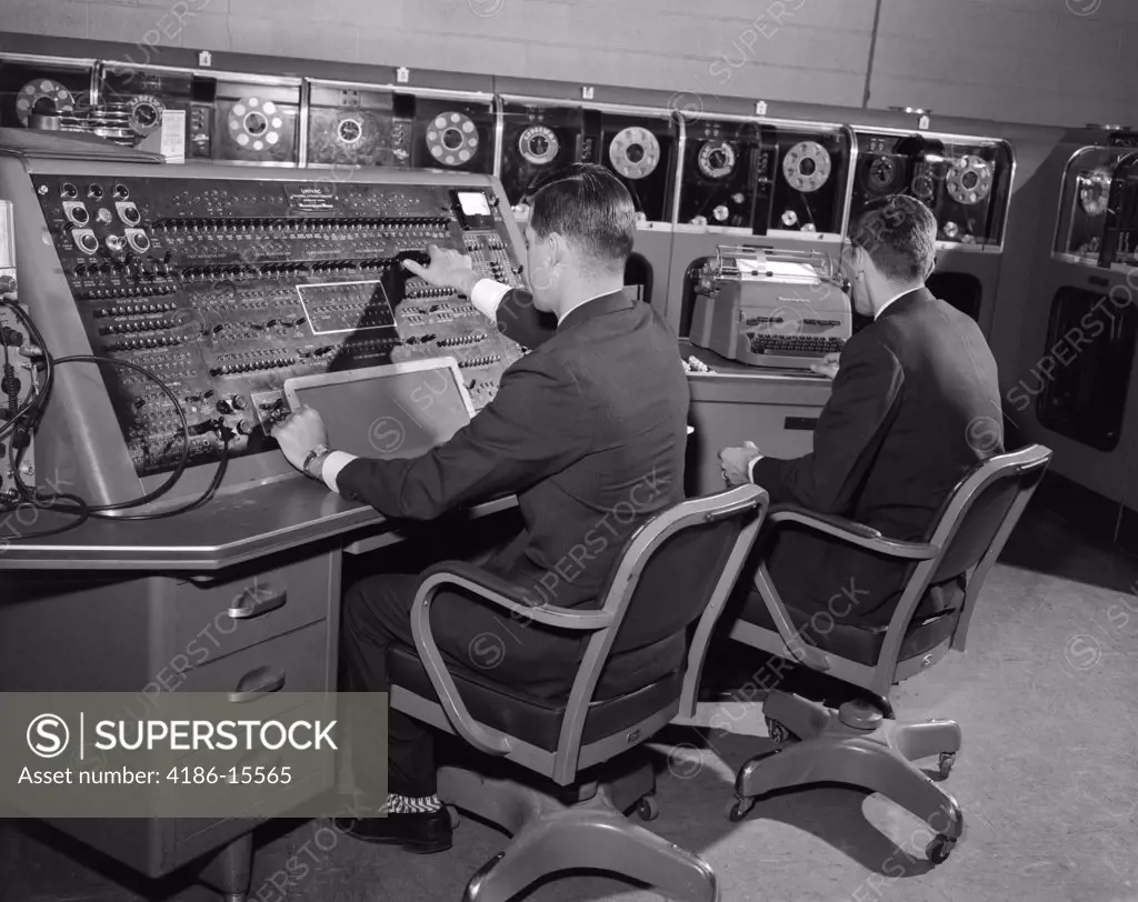 1950S 1960S Univac Computer Room With Two Men Working At Console And Typewriter Keyboard