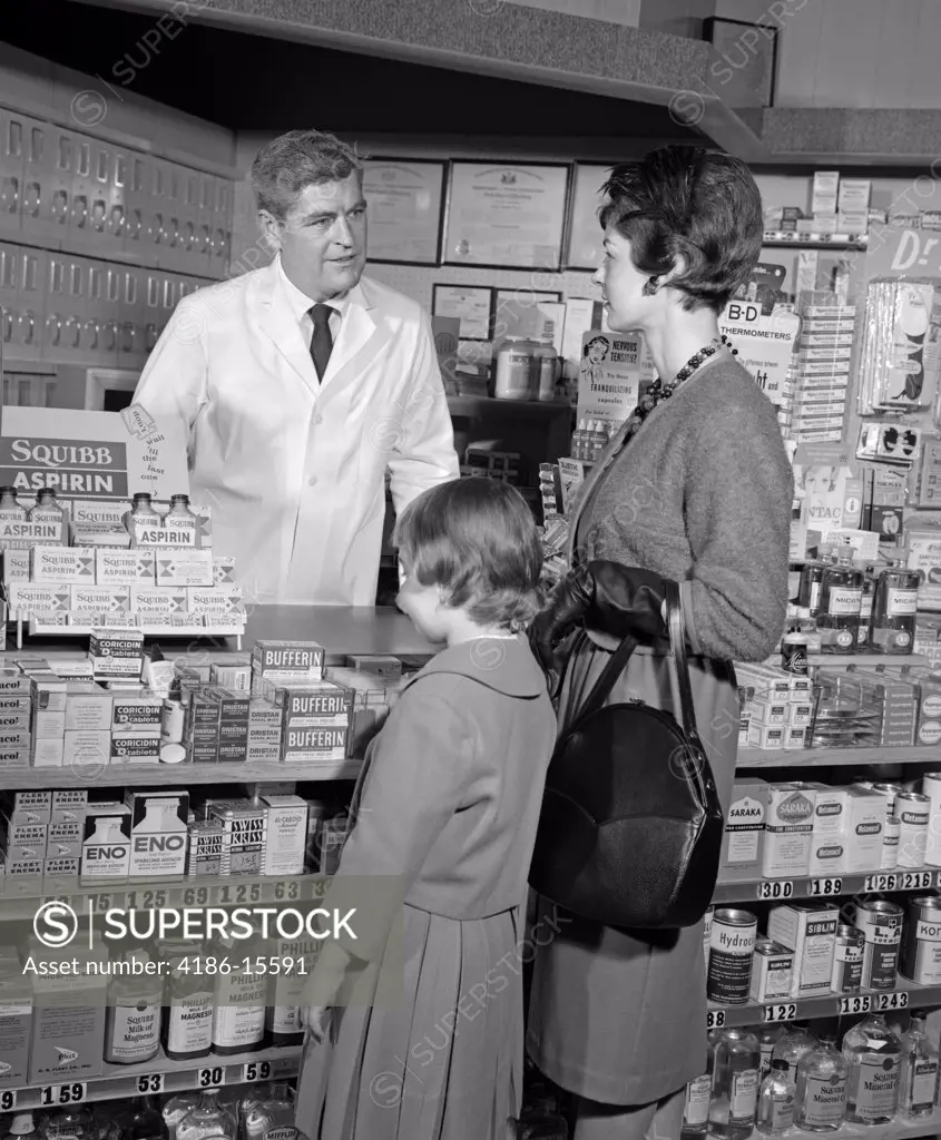 1950S 1960S Mother Daughter Counter Pharmacy Pharmacist Behind Counter Shelves Stocked Aspirin Products Medicine