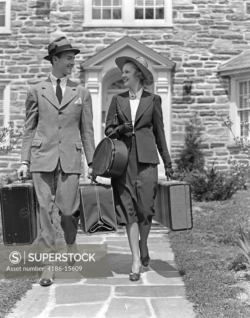 1930S 1940S Smiling Couple Leaving Home Carrying Luggage