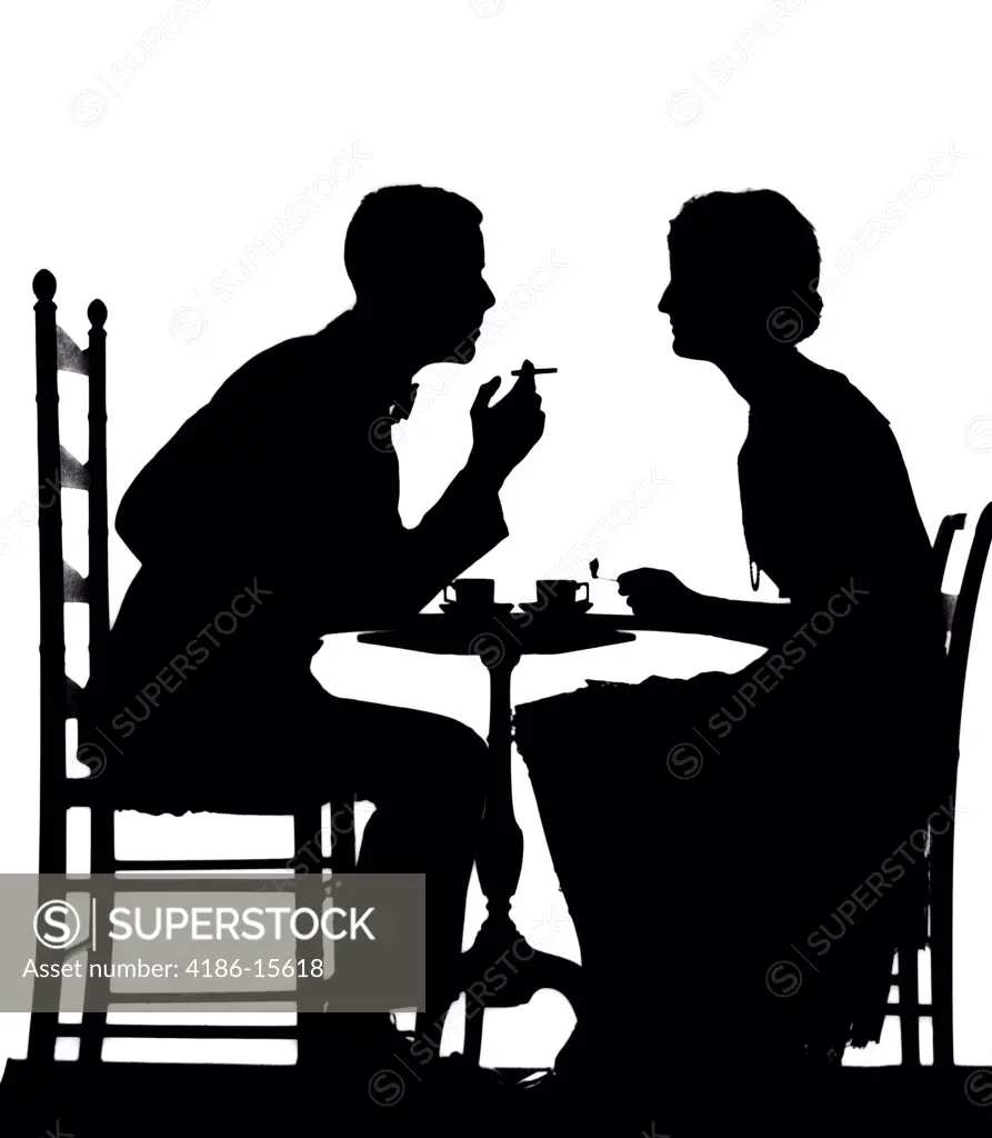 1920S Couple At Table With Teacups Man Smoking Cigarette