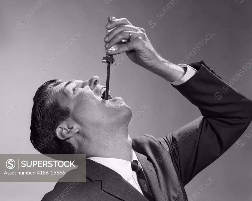 1960S Businessman Swallowing Sword