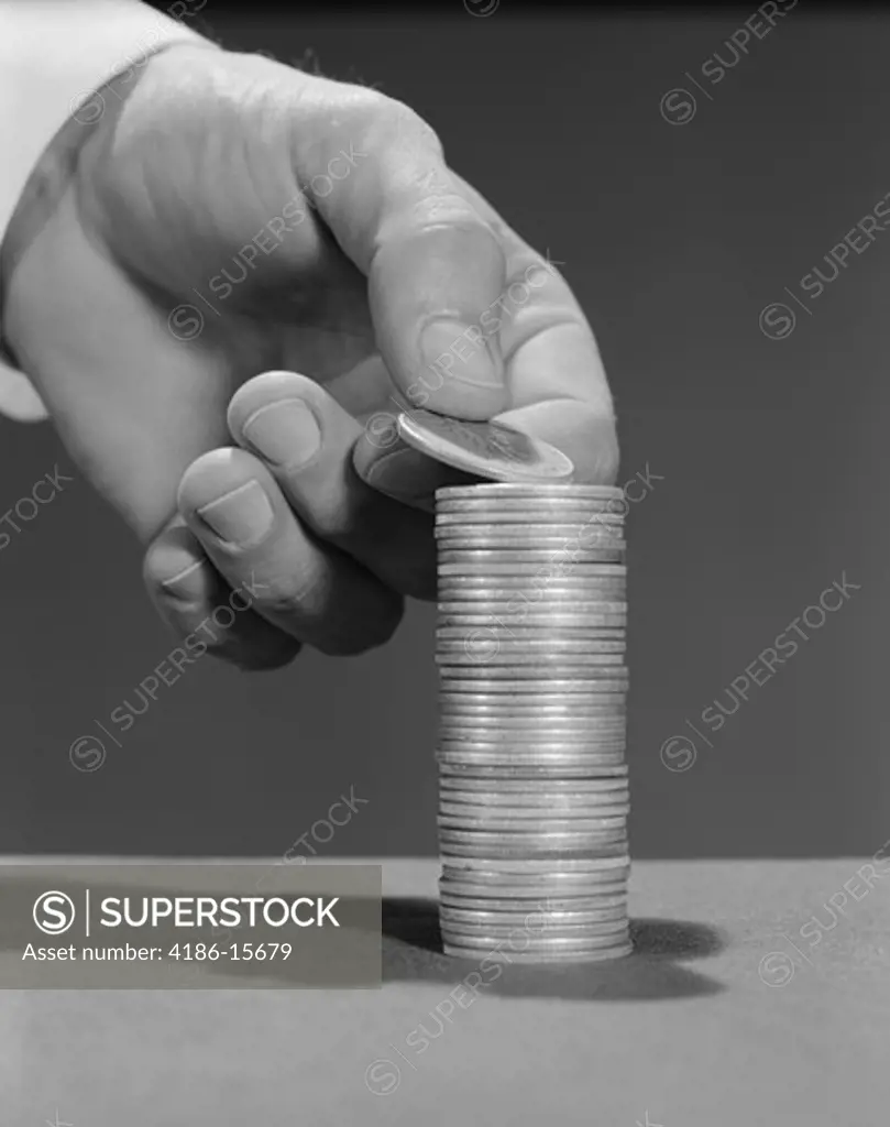 1960S Male Hand Stacking Coins Money