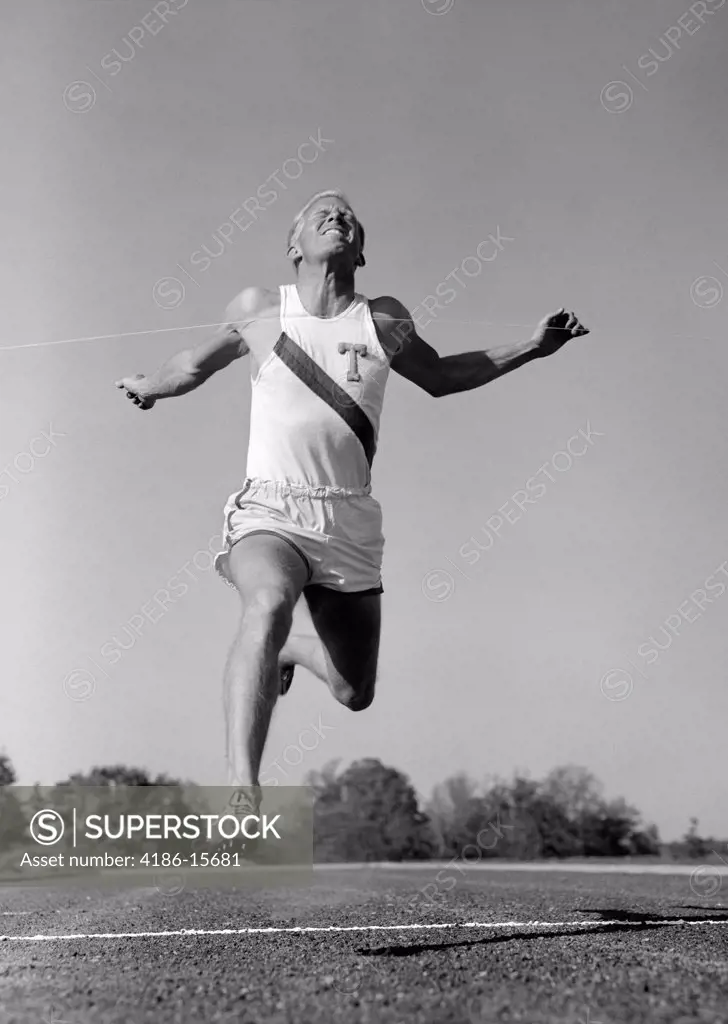 1960S Man Running Winning Sprinting Across The Finish Line Outdoor