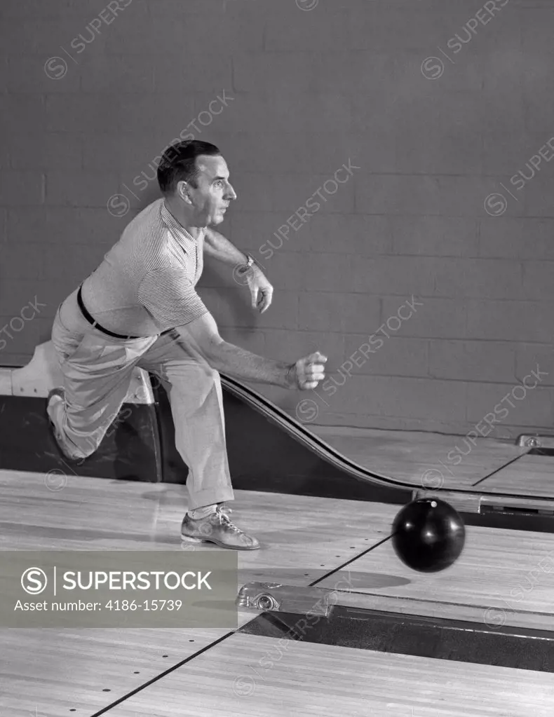 1950S Man Throwing Bowling Ball Down Bowling Alley Lane