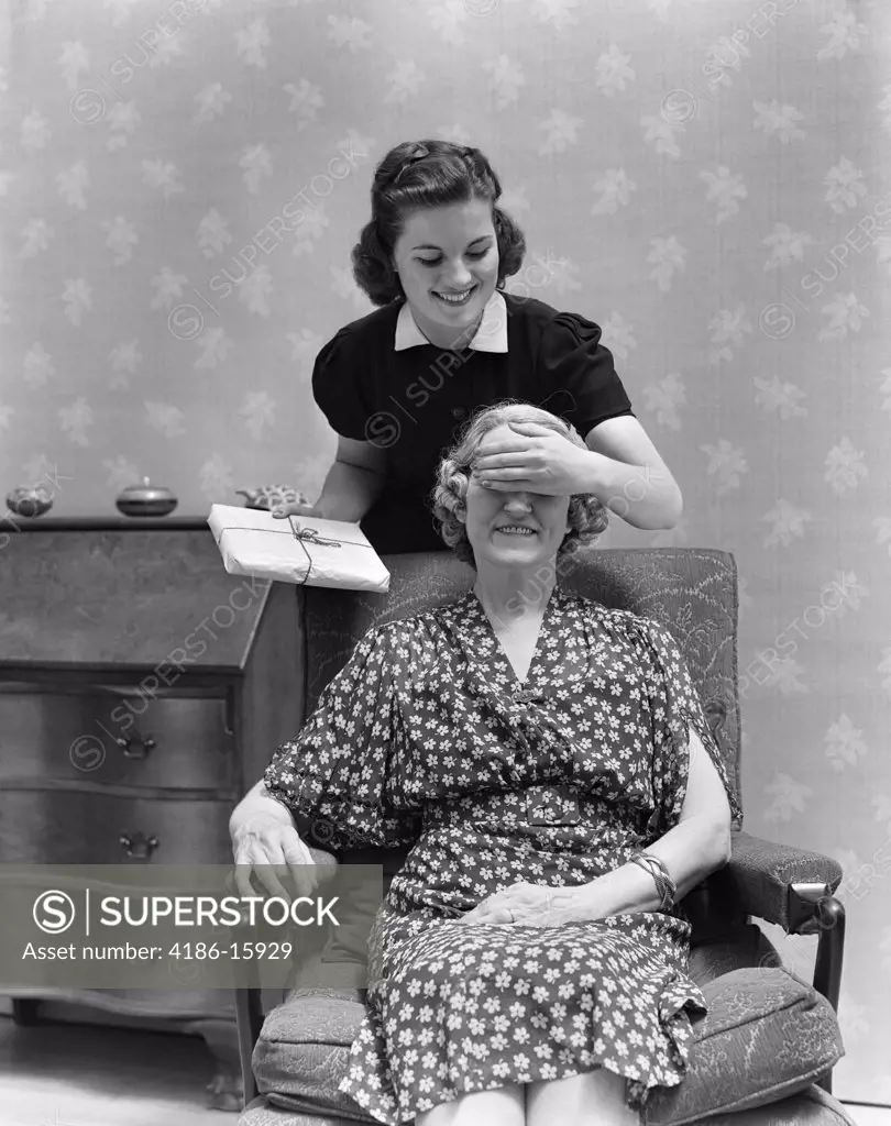 1940S Two Women Mother Daughter Daughter'S Hand Covering Mother'S Eyes Holding Present Surprise