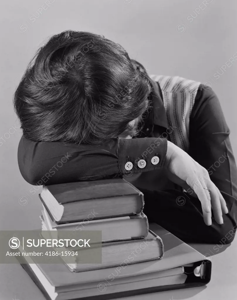 1970S Female Student Head Resting On Stack Of Books Sleeping