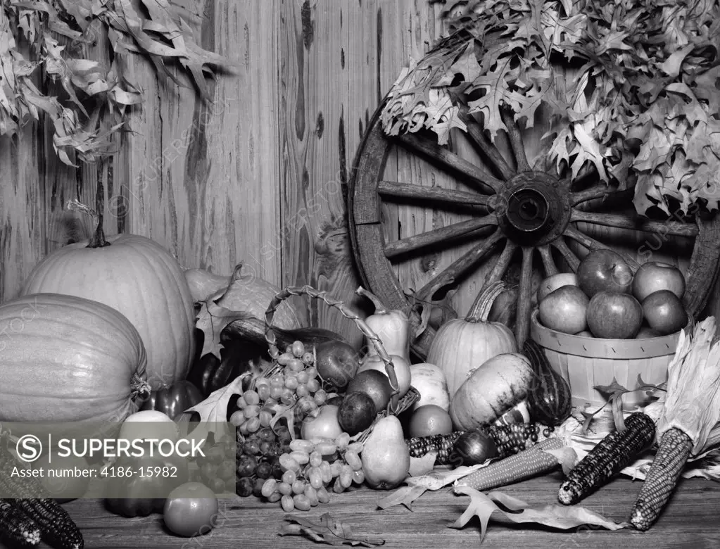 1970S Still Life Of Fall Harvest Fruits & Vegetables Set Up In Front Of Wagon Wheel