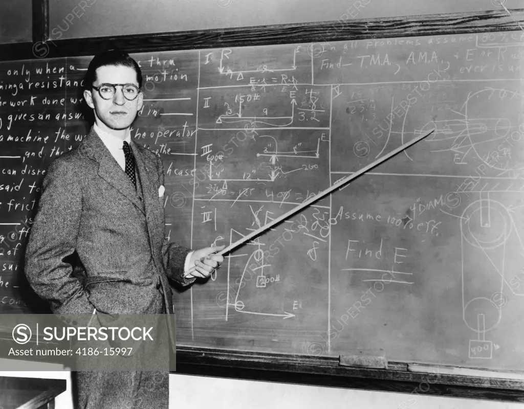 1930S 1940S Man Teacher Professor Pointing Pointer At Blackboard Looking At Camera