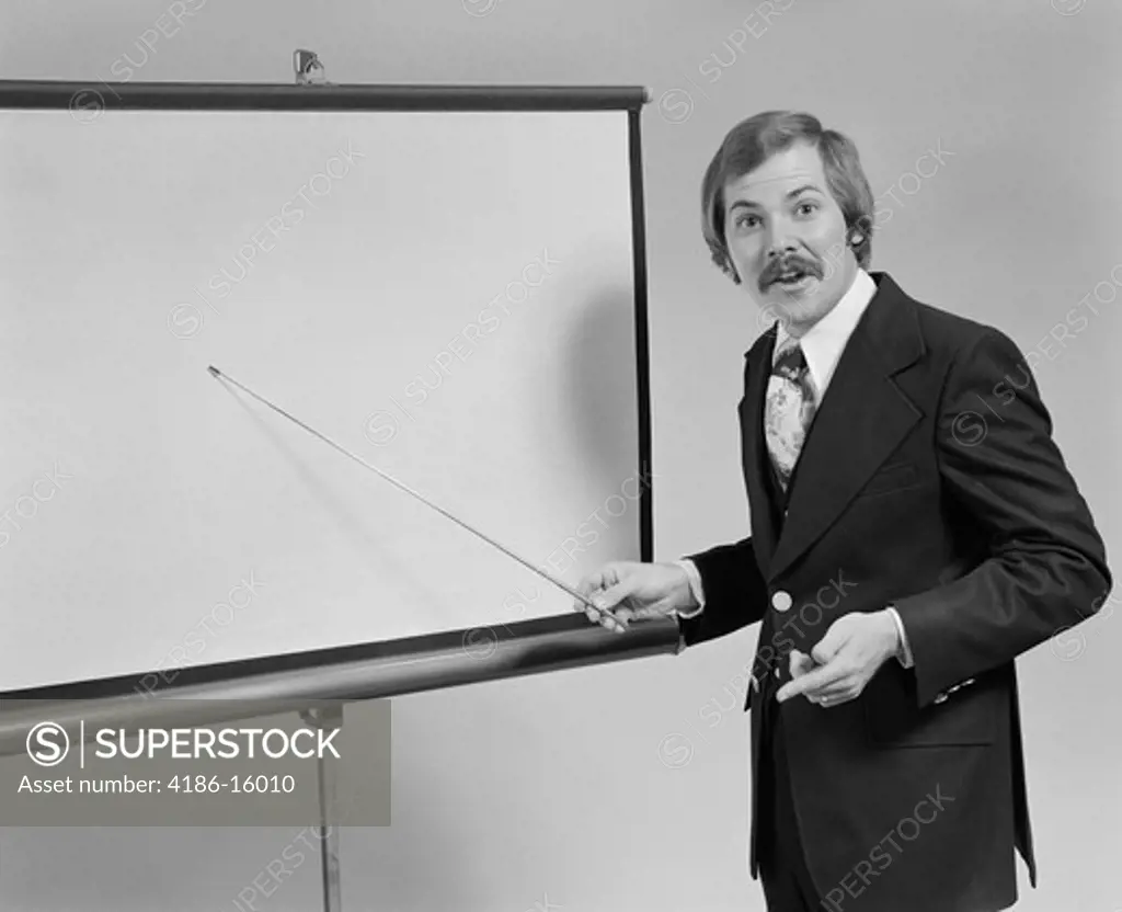 1970S Young Man Speaking Pointing To Blank Slide Screen For Presentation