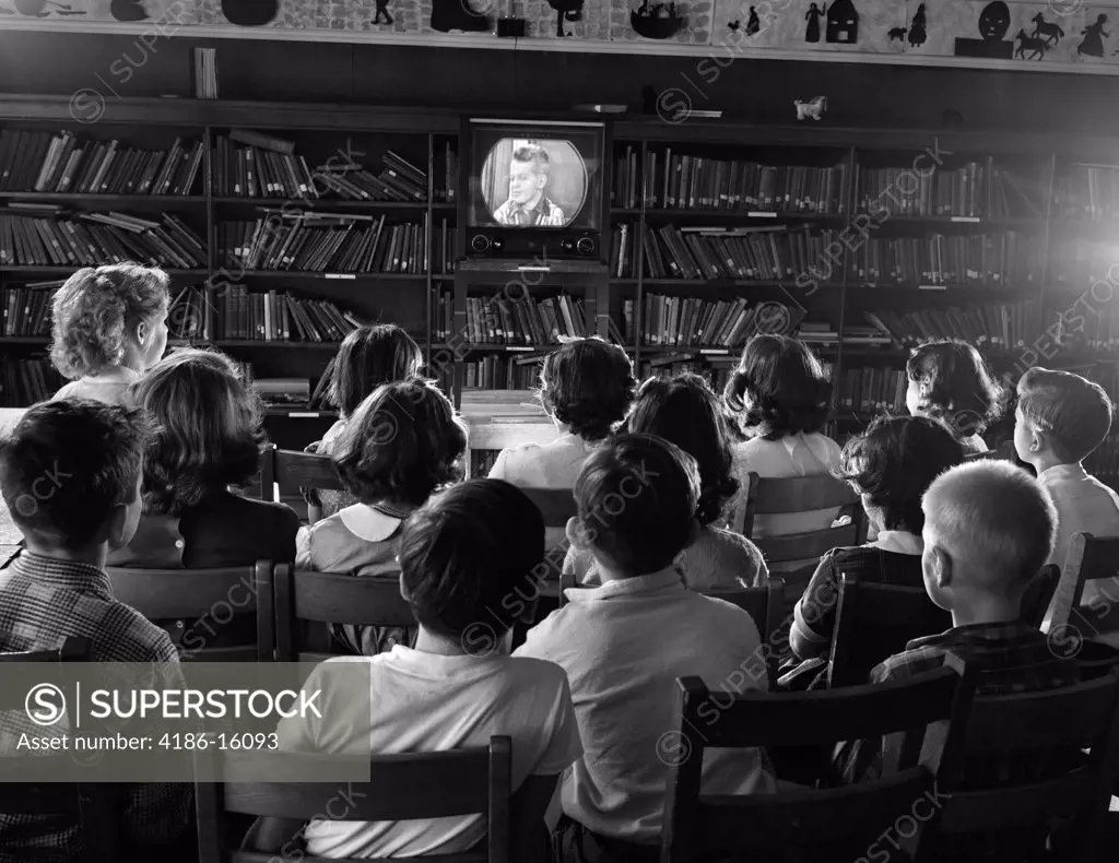 1950S Back View Of Kids In School Library Watching Tv Screen