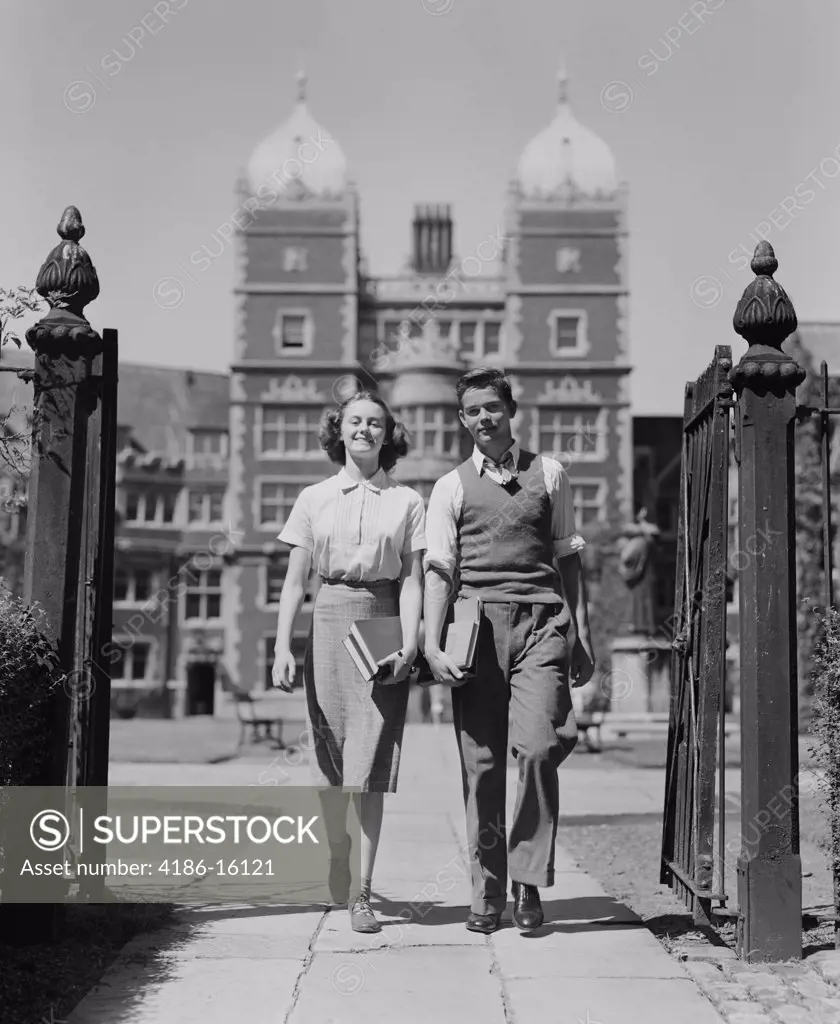 1940S College Aged Student Couple Walking Through Campus Gates University Of Pennsylvania