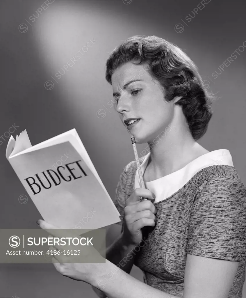 1940S Woman Holding Budget Book With Pencil To Chin