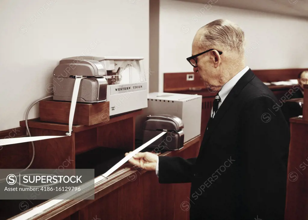 1960s SENIOR MAN STOCK AND BOND INVESTOR BROKER ADVISOR CONSULTANT READING STOCK TICKER TAPE 