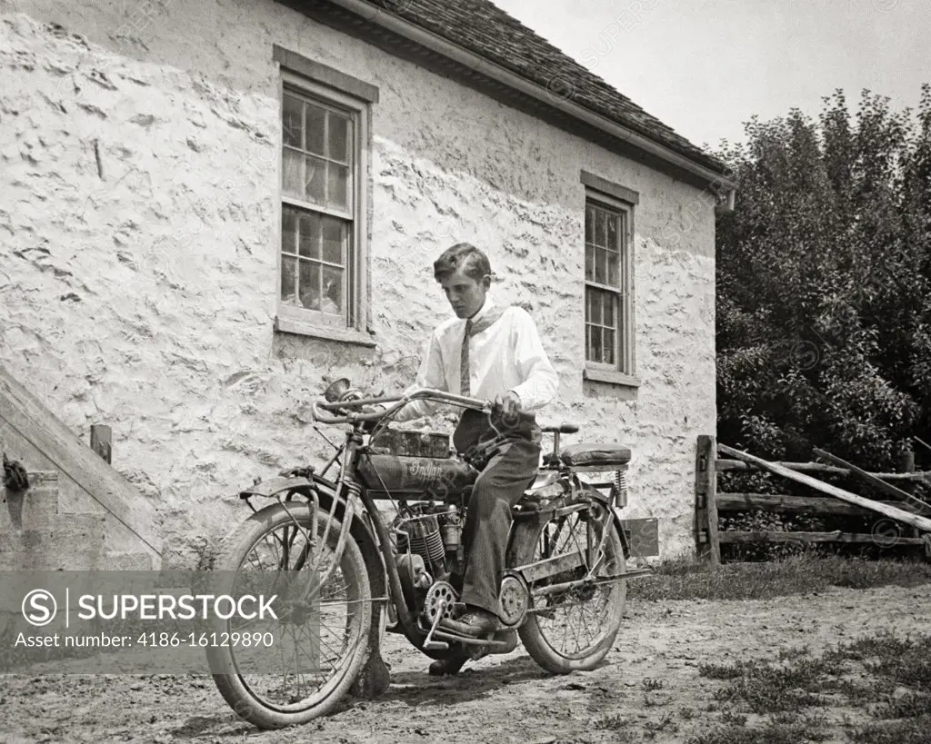 1910s ANONYMOUS YOUNG MAN WEARING WHITE SHIRT AND TIE SITTING ON INDIAN MOTORCYCLE CIRCA 1915