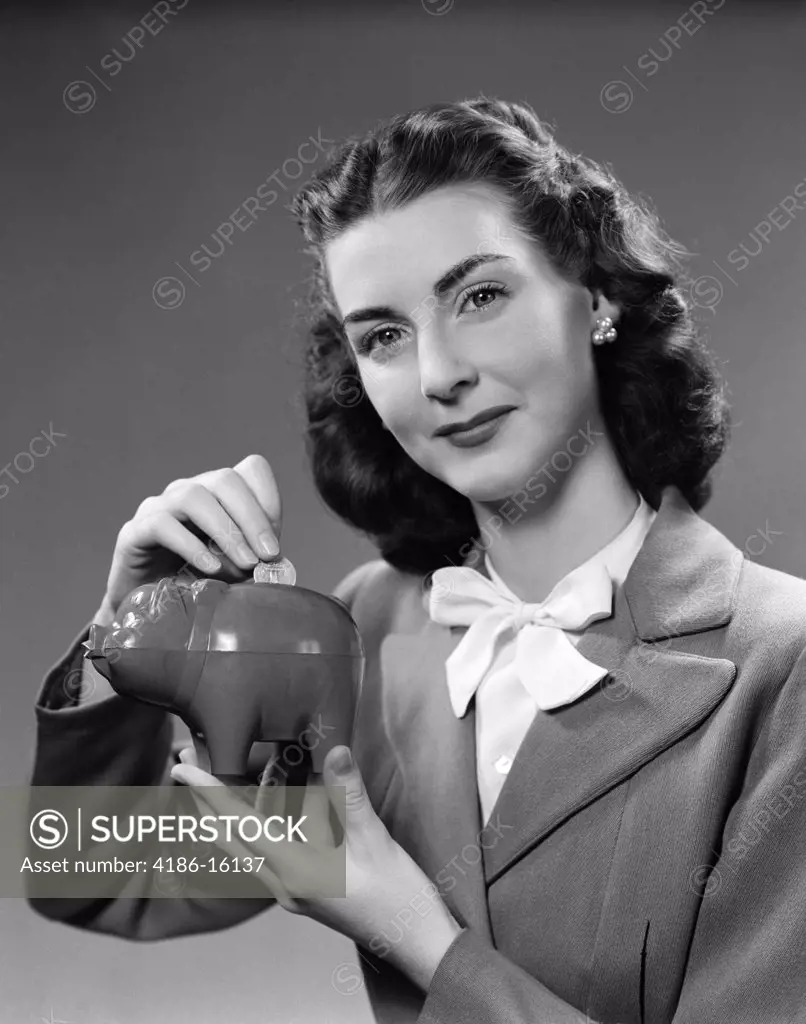 1940S Woman Putting Change Into Piggy Bank