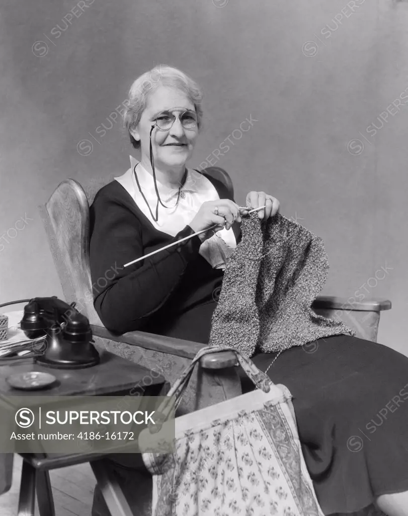1930S Elderly Smiling Woman Wearing Pince-Nez Glasses Sitting Knitting