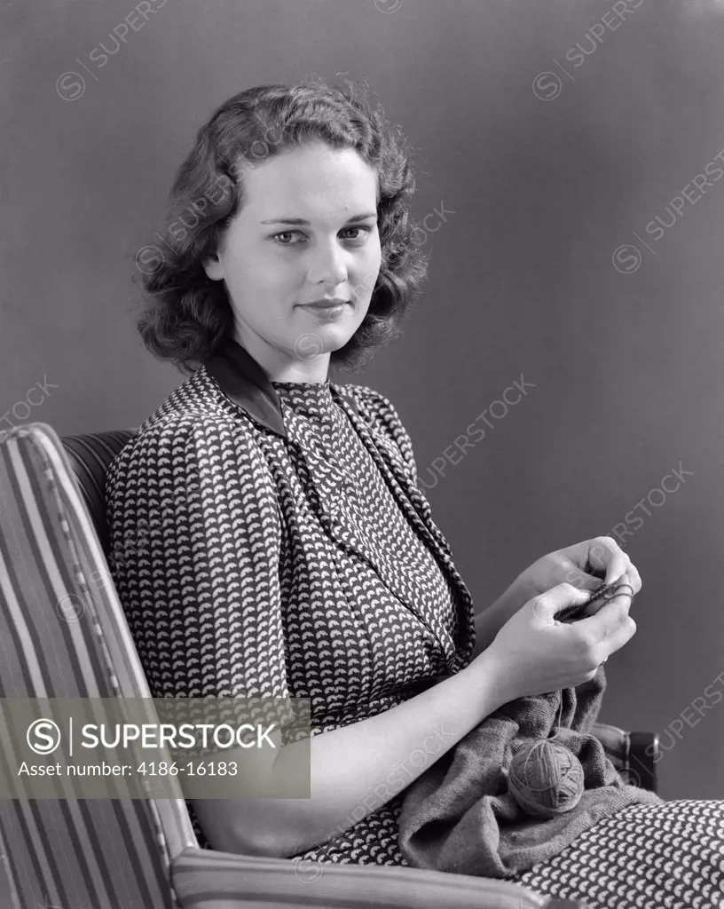 1940S Woman Sitting In Chair Knitting