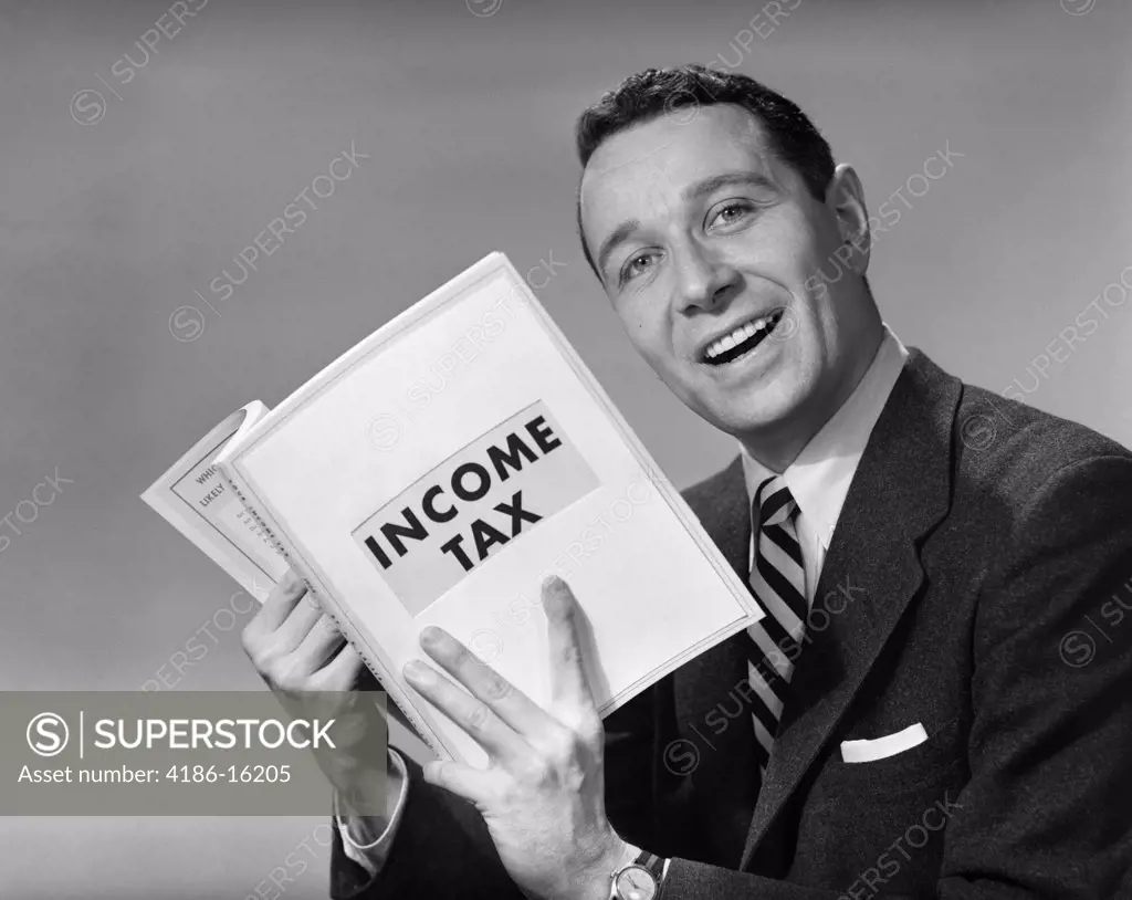 1950S Man In Suit With Income Tax Book In Hand